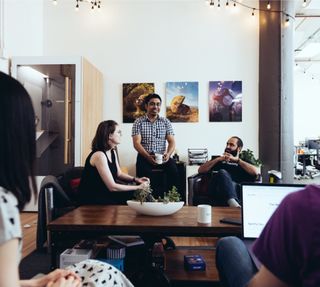 Four Netlifiers in conversation in the office’s lounge area