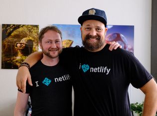 Matt and Chris wearing their Netlify t-shirts and smiling
